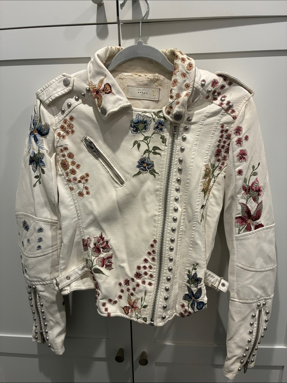Blank NYC Embroidered White Faux Leather Moto Jacket with Stud Details